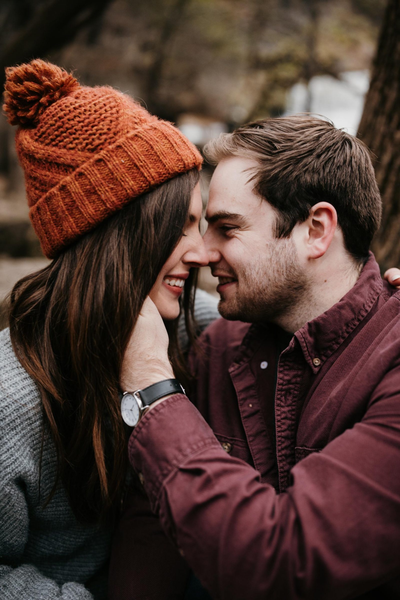 Engagement pictures of Garrett and Morgan touching noses and smiling.