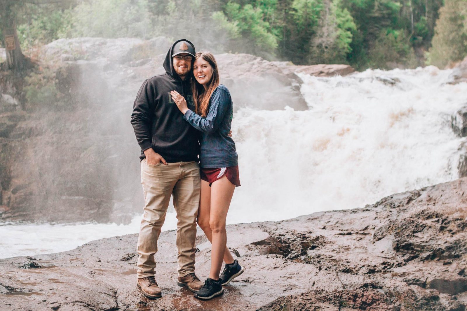 Garrett and morgan after getting engaged in Wisconsin in front of a waterfall